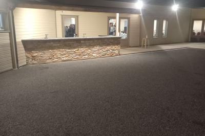 Paysage rural avec une ferme traditionnelle entourée de champs verdoyants et d'arbres sous un ciel nuageux.