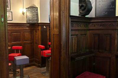 Groupe de personnes discutant dans un espace intérieur éclairé par des lumières vertes, ambiance conviviale.