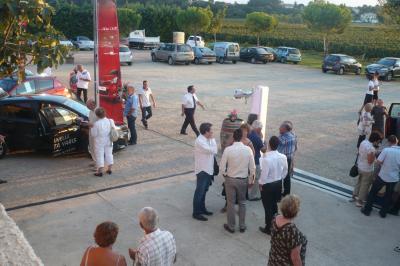Salle avec des participants assis face à une présentation, entourée de drapeaux publicitaires et d'éléments décoratifs.