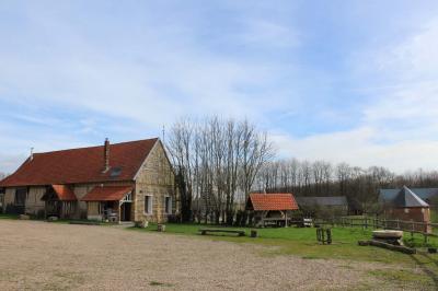 Miniature Location salle Montivilliers (Seine-Maritime) - Ferme d'Epaville #24 Salle rustique avec murs en pierre et poutres apparentes, aménagée avec tables hautes, canapés et décorations simples.