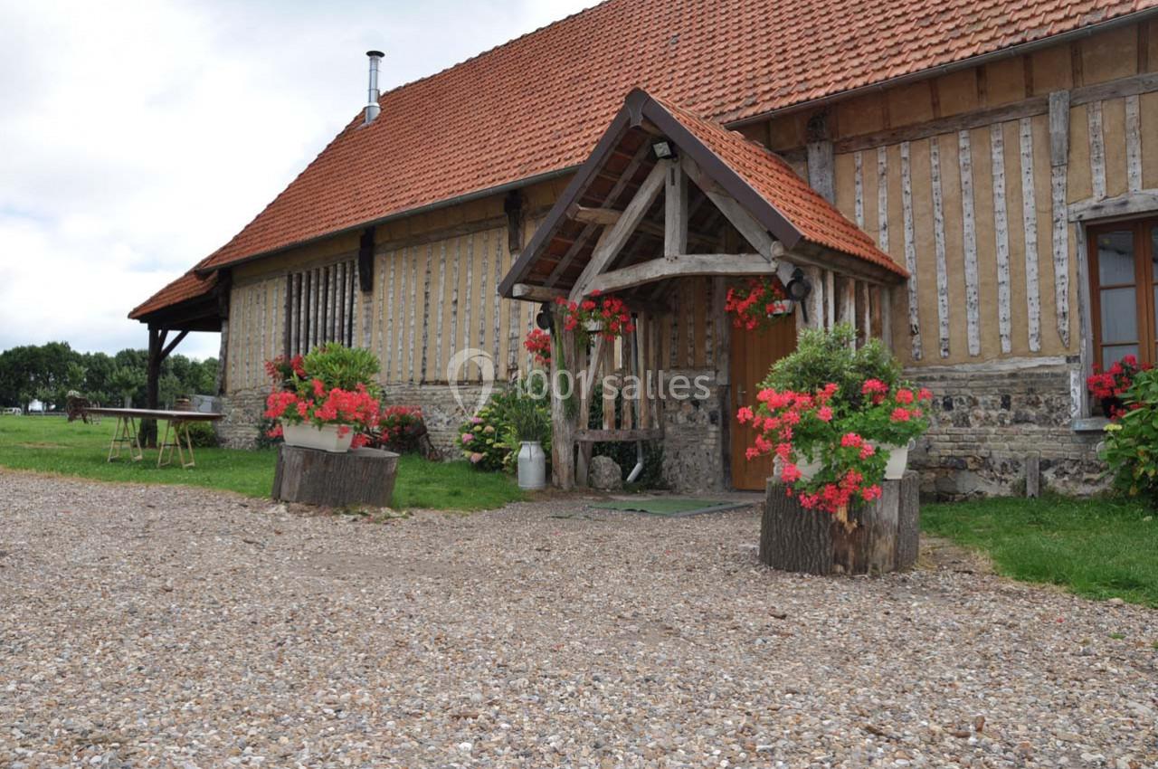 Location salle Montivilliers (Seine-Maritime) - Ferme d'Epaville #30 Façade d'une maison à colombages avec toit en tuiles, jardinières fleuries et entrée abritée par une structure en bois.