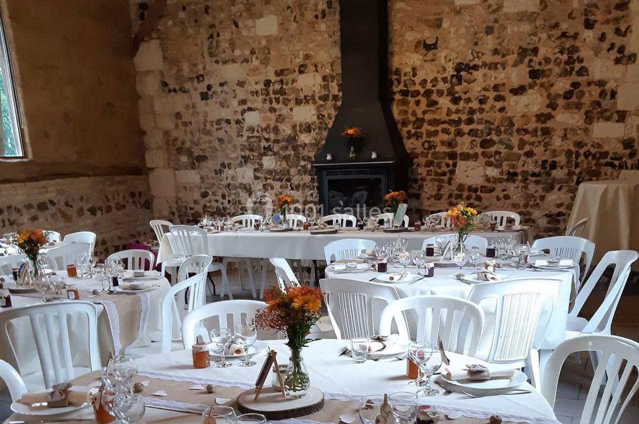 Location salle Montivilliers (Seine-Maritime) - Ferme d'Epaville #8 Salle décorée pour un événement avec des tables dressées, des chaises blanches et des fleurs en centre de table.