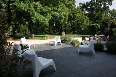 Table de billard en bois avec tapis vert dans une pièce au style rustique, avec poutres apparentes et murs en briques.