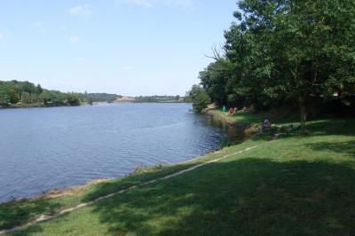 Cuisine professionnelle avec plan de travail en inox, lave-vaisselle industriel et casiers de rangement colorés.