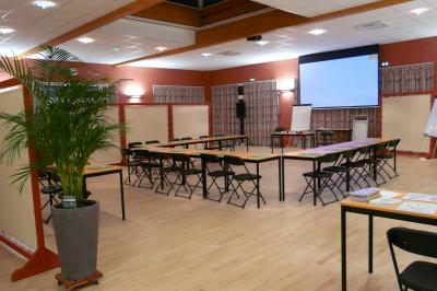 Cuisine professionnelle avec plan de travail en inox, lave-vaisselle industriel et casiers de rangement colorés.