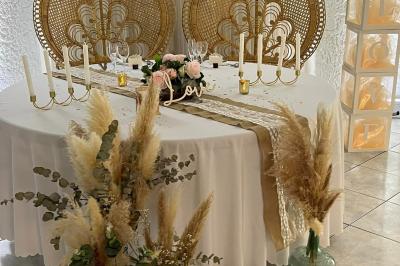 Pièce montée en choux avec figurines de mariés et une inscription en sucre, décorée d'une étincelle allumée.