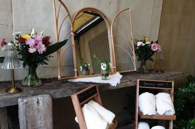 Château gonflable blanc installé sur une surface gravillonnée, entouré de végétation et de mobilier de jardin.