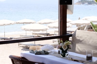 Carte illustrée de Ramatuelle placée sur une table décorée avec des citrons, des verres et une nappe en toile de jute.