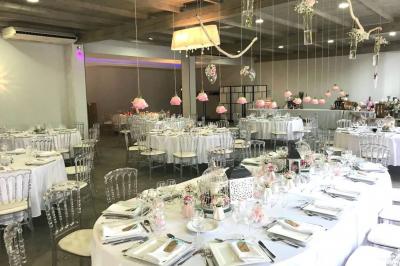 Un parking extérieur rempli de voitures, entouré de végétation et éclairé par une lumière naturelle.