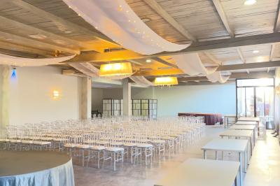 Un parking extérieur rempli de voitures, entouré de végétation et éclairé par une lumière naturelle.