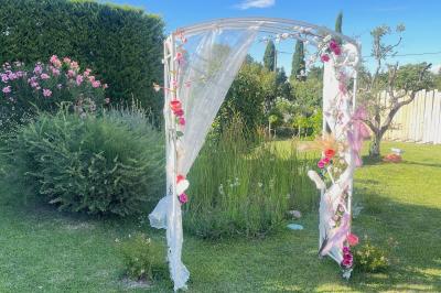 Un parking extérieur rempli de voitures, entouré de végétation et éclairé par une lumière naturelle.