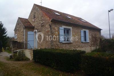 Disposition de chaises blanches en extérieur autour d'une allée menant à une petite scène sous une tente blanche.
