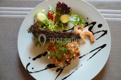 Assiette de salade garnie de magret de canard, asperges, figues, tomates séchées et filet de sauce balsamique.