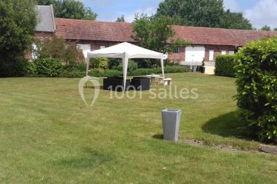 Lit avec coussins colorés et décoration murale en macramé dans une chambre lumineuse.
