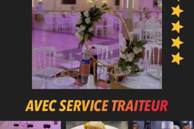 Salle de réception décorée avec tables dressées, compositions florales, buffet, plats servis et pièce montée.