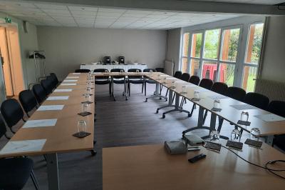 Circuit de course miniature avec des pistes sinueuses, des décors et des structures sur une table dans une salle.