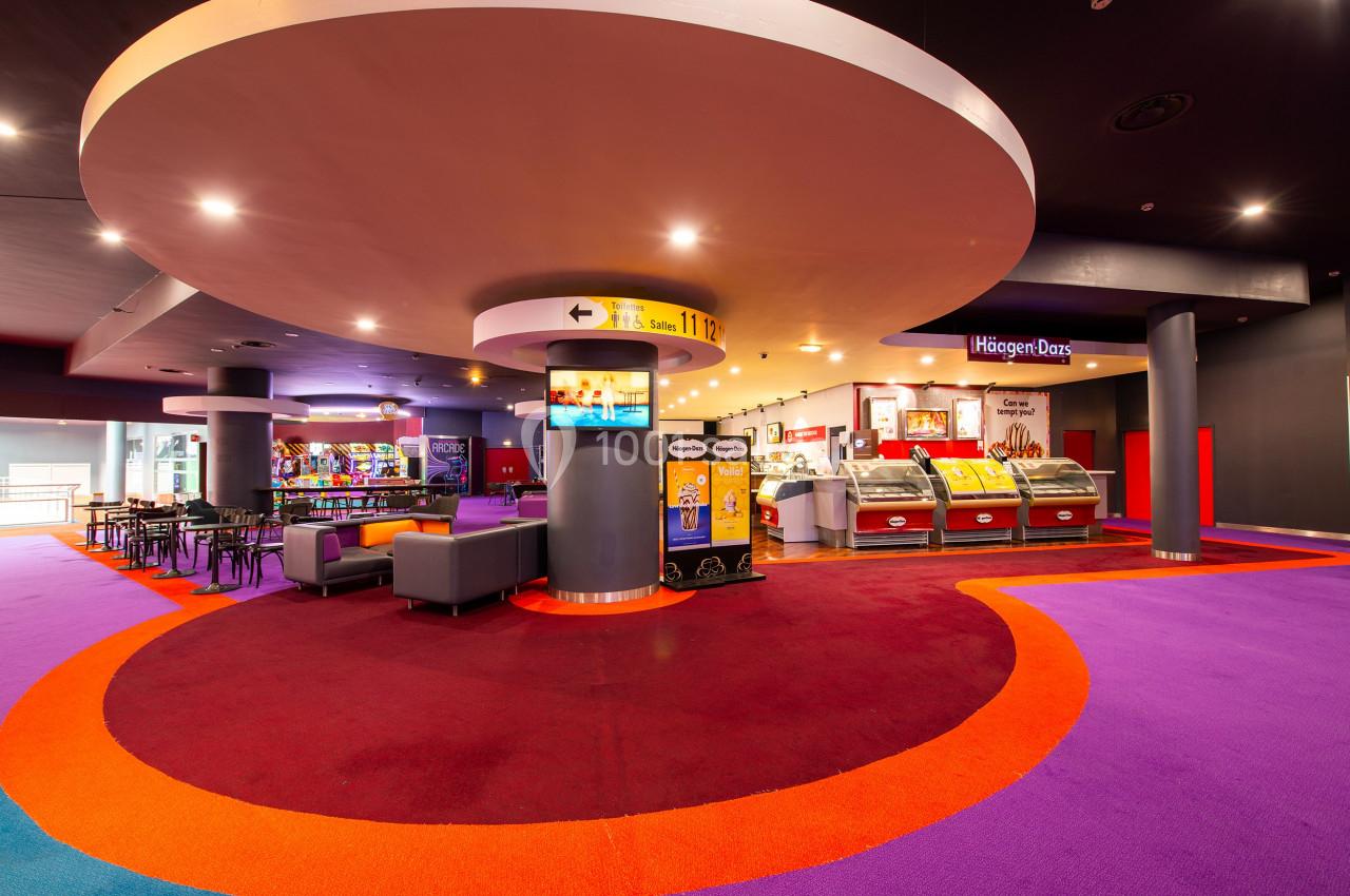 Espace intérieur coloré avec coin salon, comptoir de glaces Häagen-Dazs et signalétique lumineuse.