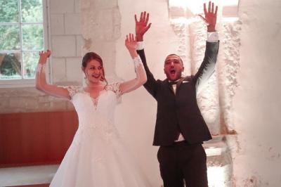 Un grand groupe de personnes posant devant un bâtiment historique en pierre avec des fenêtres et des balcons.