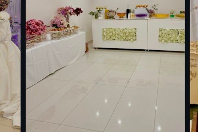 Salle lumineuse avec buffet décoré de fleurs, contenant des plats et boissons, sur un sol en carrelage blanc.