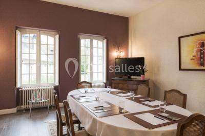 Forêt illuminée par le soleil couchant, avec des arbres espacés et un sentier couvert de feuilles au sol.