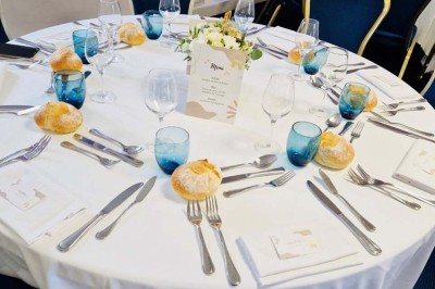 Bâtiment d'hôtel en pierre avec trois étoiles, entouré de végétation et d'une façade partiellement recouverte de lierre.