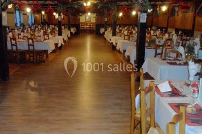 Grandes bûches pâtissières décorées de glaçage blanc, présentées sur une table ornée de guirlandes lumineuses et de…
