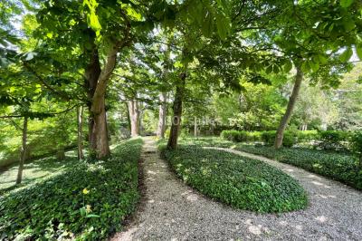 Voûtes en pierre éclairées par des lumières murales, avec des fenêtres laissant entrer la lumière naturelle.