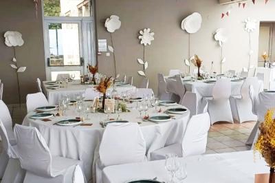 Deux lavabos blancs sur un meuble en bois avec miroirs, distributeur de savon mural et poubelle dans une salle de bain…