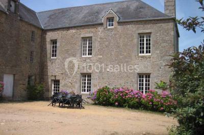Chambre lumineuse avec lit à baldaquin, armoire à miroir, chaise en bois et rideaux rouges encadrant une fenêtre ouverte.