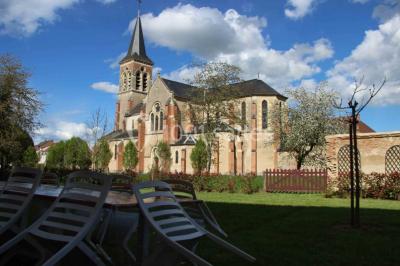 Miniature Location salle Beaulon (Allier) - Château de Beaulon #20 Vue nocturne d'un château illuminé entouré d'arbres, avec une allée sombre au premier plan.