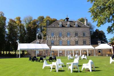Terrain en cours d'aménagement avec une surface en gravier, entouré de verdure et proche d'un espace de jeux clôturé.
