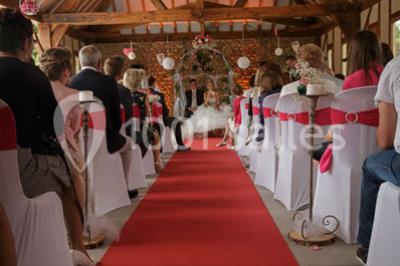 Chambre mansardée avec quatre lits simples, couvertures bleues et étagère en bois clair contre un mur gris.