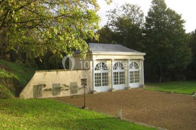 Deux lits simples en bois avec couvre-lits bleus dans une chambre mansardée aux murs bleus et parquet au sol.