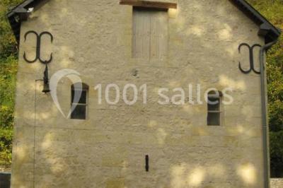 Deux lits simples en bois avec couvre-lits bleus dans une chambre mansardée aux murs bleus et parquet au sol.