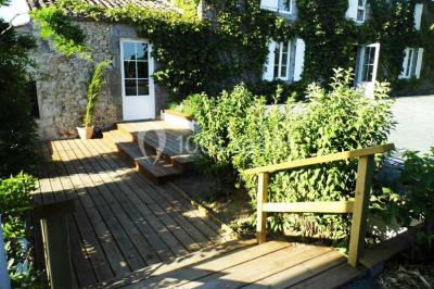 Vue aérienne d'une propriété rurale avec plusieurs bâtiments, une piscine, une tente blanche et des champs environnants.