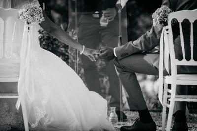 Entrée d'un bâtiment éclairé en soirée, avec des plantes décoratives et des personnes visibles à l'intérieur.