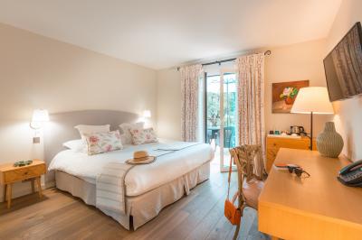 Salle de bain avec baignoire, lavabo moderne sur meuble noir, miroir mural et lumière naturelle par une fenêtre.