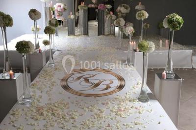 Salle de réception avec bar éclairé par des lumières colorées et invités rassemblés dans une ambiance tamisée.