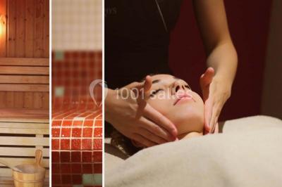 Lavabo avec plan en bois, sèche-serviettes mural, douche avec paroi vitrée et carrelage sombre.