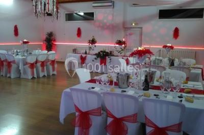 Jeu de lumières colorées dans une salle sombre avec équipement de sonorisation visible en arrière-plan.