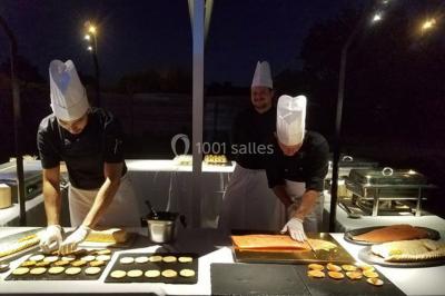 Étang entouré de pelouses et de bouleaux sous un ciel bleu clair.