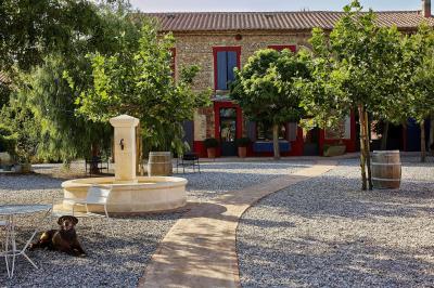 Un artiste chante sur scène avec une personne en costume étincelant sous des lumières violettes, devant un public assis.