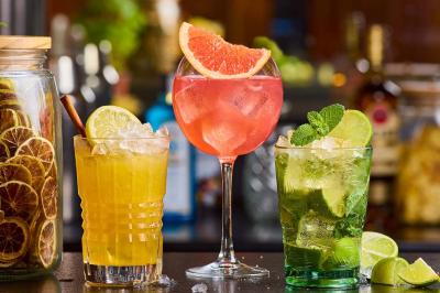 Plat de viande rouge tranchée avec sauce au poivre, accompagné de frites, servi sur un plateau avec un verre de vin rouge.