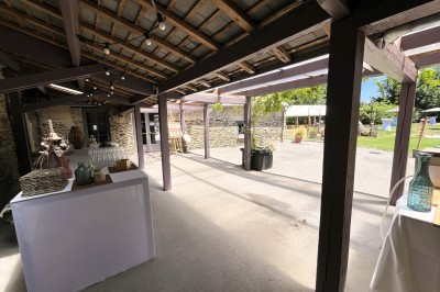 Chambre mansardée avec lit double, poutres apparentes, éclairage chaleureux et fenêtre de toit.