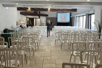 Allée bordée d'arbres et d'arbustes, avec un sol en gravier sous un ciel bleu dégagé.