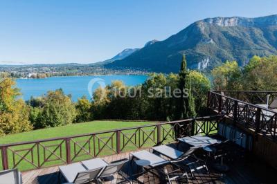 Deux personnes jouent au mini-golf sur un terrain entouré de végétation, avec une cabane perchée visible en arrière-plan.