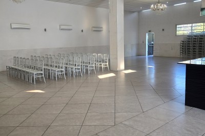 Table de réception élégamment dressée avec nappes blanches, serviettes décorées, verres et couverts alignés.