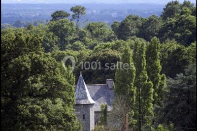 Paysages naturels avec lac entouré de forêts, sentiers boisés et ponton au bord de l'eau sous un ciel partiellement nuageux.