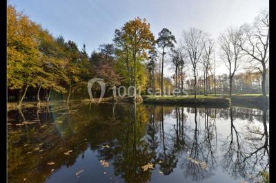Miniature Location salle Piré-sur-Seiche (Ille-et-Vilaine) - Domaine du Château des Pères #25 Lit double avec une couverture blanche, des coussins colorés et une robe de mariée posée sur le côté.