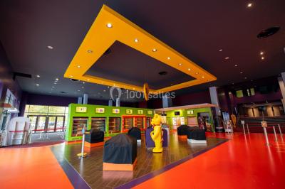 Miniature Location salle Caen (Calvados) - Pathé Les Rives de l'Orne #10 Intérieur d'un bâtiment moderne avec escalier, rambardes en métal, murs colorés et grandes baies vitrées.